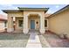 Inviting home entrance showcasing a well-maintained yard and charming architectural details at 4007 W Red Coach Ave, North Las Vegas, NV 89031