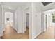 Bright hallway with hardwood floors leading to various rooms and a bathroom at 4007 W Red Coach Ave, North Las Vegas, NV 89031