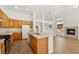 Functional kitchen with an island sink, ample cabinetry, and easy access to the living area and fireplace at 4007 W Red Coach Ave, North Las Vegas, NV 89031
