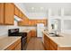 Efficient kitchen with wood cabinets, a practical layout, and modern appliances for convenient cooking at 4007 W Red Coach Ave, North Las Vegas, NV 89031