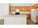 Functional kitchen boasts wood cabinets, a central island with sink, and modern appliances for easy meal prep at 4007 W Red Coach Ave, North Las Vegas, NV 89031