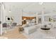 Bright, open-concept living area with modern furnishings and a view of the kitchen at 4007 W Red Coach Ave, North Las Vegas, NV 89031