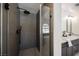 Modern bathroom with gray tile walk-in shower and glass partition, plus stylish vanity with black fixtures at 4016 Tyler William Ln, Las Vegas, NV 89130