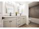 Bright bathroom boasts double vanity with white countertops, modern fixtures, and stylish mirrors at 4016 Tyler William Ln, Las Vegas, NV 89130
