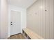 Entryway featuring a white front door, bench with storage, and board and batten wall detail at 4016 Tyler William Ln, Las Vegas, NV 89130