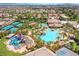 Aerial view of the community showcasing pools, tennis courts, playground, and lush landscaping in a Gathering-friendly setting at 44 Tamarron Cliffs St, Las Vegas, NV 89148