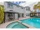 Beautiful backyard features a sparkling pool, hot tub, and outdoor seating area at 44 Tamarron Cliffs St, Las Vegas, NV 89148