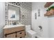 Stylish powder room with a modern vanity, decorative mirror, and patterned accent wall at 44 Tamarron Cliffs St, Las Vegas, NV 89148