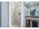 Elegant bathroom featuring a glass-enclosed shower and a bar with a wine fridge at 44 Tamarron Cliffs St, Las Vegas, NV 89148