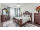 Well-lit bedroom with a dark wood bed frame and large windows, providing ample natural light at 44 Tamarron Cliffs St, Las Vegas, NV 89148