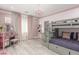 Charming pink and gray bedroom featuring a bunk bed with stairs and a vanity with a decorative chandelier at 44 Tamarron Cliffs St, Las Vegas, NV 89148