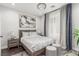 Stylish bedroom with contemporary decor, featuring a decorative light fixture and neutral color palette at 44 Tamarron Cliffs St, Las Vegas, NV 89148