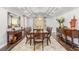 Formal dining room featuring an elegant chandelier, a large wooden table, and decorative accents at 44 Tamarron Cliffs St, Las Vegas, NV 89148