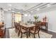 Formal dining room featuring an elegant chandelier, a large wooden table, and decorative accents at 44 Tamarron Cliffs St, Las Vegas, NV 89148