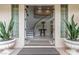 Grand foyer showcasing a curved staircase, elegant decor, and a glimpse of the home's interior at 44 Tamarron Cliffs St, Las Vegas, NV 89148