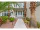 Elegant front entrance with double doors, lush landscaping, and walkway lighting at 44 Tamarron Cliffs St, Las Vegas, NV 89148