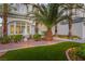 Inviting front yard featuring lush greenery, a decorative fountain, and a well-lit walkway at 44 Tamarron Cliffs St, Las Vegas, NV 89148