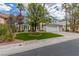 Attractive home with a manicured front lawn, mature palm trees, and a spacious driveway at 44 Tamarron Cliffs St, Las Vegas, NV 89148