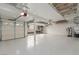 Large garage with epoxy flooring, water softener, and overhead storage at 44 Tamarron Cliffs St, Las Vegas, NV 89148