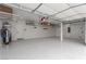 Spacious garage with epoxy flooring, storage racks, and ample lighting at 44 Tamarron Cliffs St, Las Vegas, NV 89148