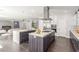 Spacious kitchen features modern cabinetry, a large island with a cooktop, and stainless steel appliances at 44 Tamarron Cliffs St, Las Vegas, NV 89148