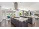 Bright kitchen with a center island cooktop, sleek stainless steel appliances, and a breakfast nook at 44 Tamarron Cliffs St, Las Vegas, NV 89148