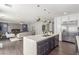Open-concept kitchen with a large island, stainless steel appliances, and seamless flow to the living area at 44 Tamarron Cliffs St, Las Vegas, NV 89148