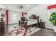Cozy main bedroom with a dark wood bed frame, hardwood floors, and a lush green plant at 44 Tamarron Cliffs St, Las Vegas, NV 89148