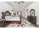 Spacious main bedroom featuring dark wood floors, elegant furniture, and bright natural lighting at 44 Tamarron Cliffs St, Las Vegas, NV 89148
