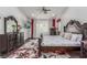 A beautifully furnished main bedroom with modern ceiling fan, dark wood furniture, and bright natural lighting at 44 Tamarron Cliffs St, Las Vegas, NV 89148