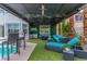 Stylish outdoor patio featuring an entertainment area with comfortable seating and a television at 44 Tamarron Cliffs St, Las Vegas, NV 89148