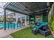 Inviting outdoor patio with a covered pergola, dining area, and pool view at 44 Tamarron Cliffs St, Las Vegas, NV 89148