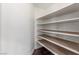 Walk-in pantry features ample shelving for organized storage, maximizing space and convenience at 44 Tamarron Cliffs St, Las Vegas, NV 89148