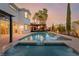 Backyard pool with spa, waterfall feature, pergola, and landscaped patio ideal for outdoor entertaining at 44 Tamarron Cliffs St, Las Vegas, NV 89148