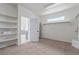 Bright walk-in closet featuring custom shelving, a window, and an open doorway to an adjoining room at 44 Tamarron Cliffs St, Las Vegas, NV 89148