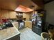 Cozy kitchen with stainless steel appliances, light wood cabinets, and a stylish tile backsplash at 4748 Obannon Dr # C, Las Vegas, NV 89102