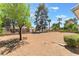 Spacious backyard with mature trees and landscaping, perfect for outdoor living at 5705 Sovereign Way, Las Vegas, NV 89130