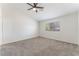 Bright bedroom featuring a ceiling fan and a large window at 5705 Sovereign Way, Las Vegas, NV 89130