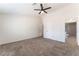 Carpeted bedroom featuring a ceiling fan and ensuite bathroom at 5705 Sovereign Way, Las Vegas, NV 89130