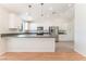 Bright kitchen features white cabinets, stainless steel appliances, and a breakfast bar at 5705 Sovereign Way, Las Vegas, NV 89130
