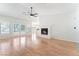 Spacious living room featuring a cozy fireplace, wood floors, and natural light at 5705 Sovereign Way, Las Vegas, NV 89130