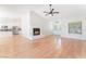 Open-concept living room featuring a fireplace, wood floors, and a vaulted ceiling at 5705 Sovereign Way, Las Vegas, NV 89130