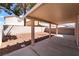 Covered back patio with concrete flooring and desert landscaping provides a welcoming outdoor space at 5978 Autumn Harvest Ave, Las Vegas, NV 89142