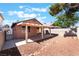 Backyard featuring a covered patio, rock landscaping, and a block wall at 5978 Autumn Harvest Ave, Las Vegas, NV 89142