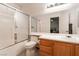 Well-lit bathroom featuring a combined tub and shower with a frosted glass sliding door at 5978 Autumn Harvest Ave, Las Vegas, NV 89142
