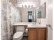 Bathroom with a tub and shower with floral shower curtain and a wood-finish vanity at 5978 Autumn Harvest Ave, Las Vegas, NV 89142