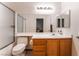 Bright bathroom featuring a tub with shower, frosted glass door, and wood-finish vanity at 5978 Autumn Harvest Ave, Las Vegas, NV 89142