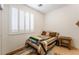 Cozy bedroom with a large window, neutral-toned walls, and minimalist decor at 5978 Autumn Harvest Ave, Las Vegas, NV 89142