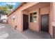 Rear exterior view of a stucco house with multiple windows and doors at 5978 Autumn Harvest Ave, Las Vegas, NV 89142