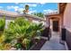 Inviting front entrance with lush greenery and wrought iron gated entry at 5978 Autumn Harvest Ave, Las Vegas, NV 89142